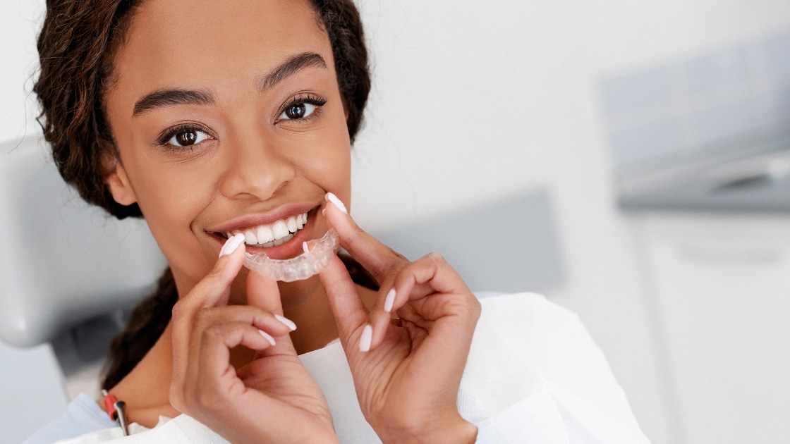 Young Woman Holding Clear Aligners